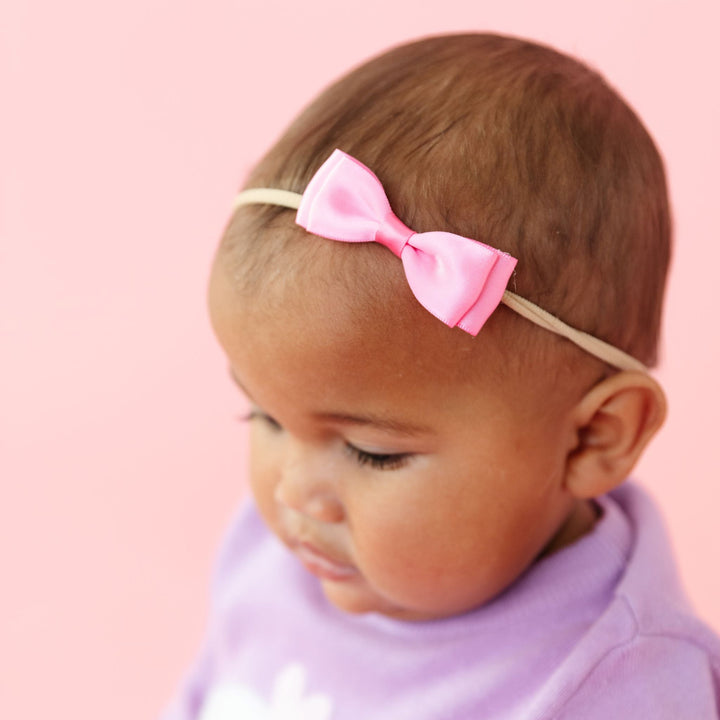 baby girl in nylon headband with pink satin double bow to match lavender Valentine's sweater