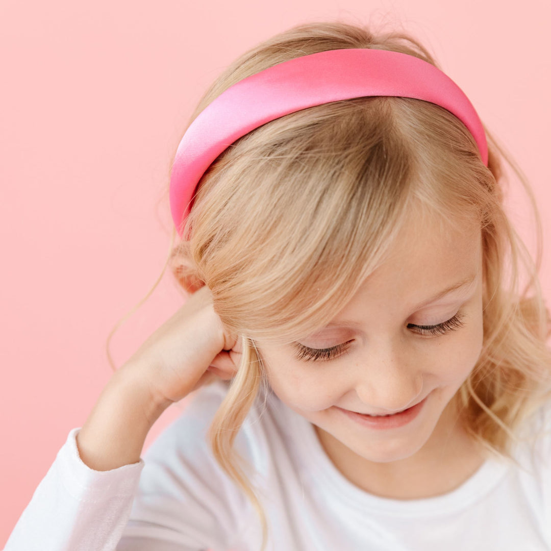 little girl in pink satin headband and white velvet dress