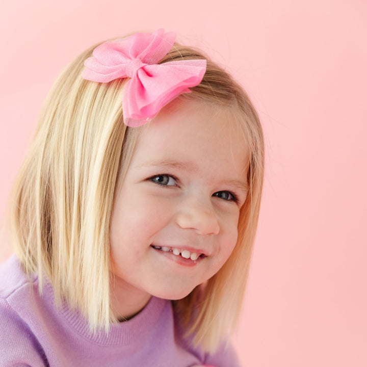 little girl in pink tutu bow on clip and lavender sweater for Valentines Day