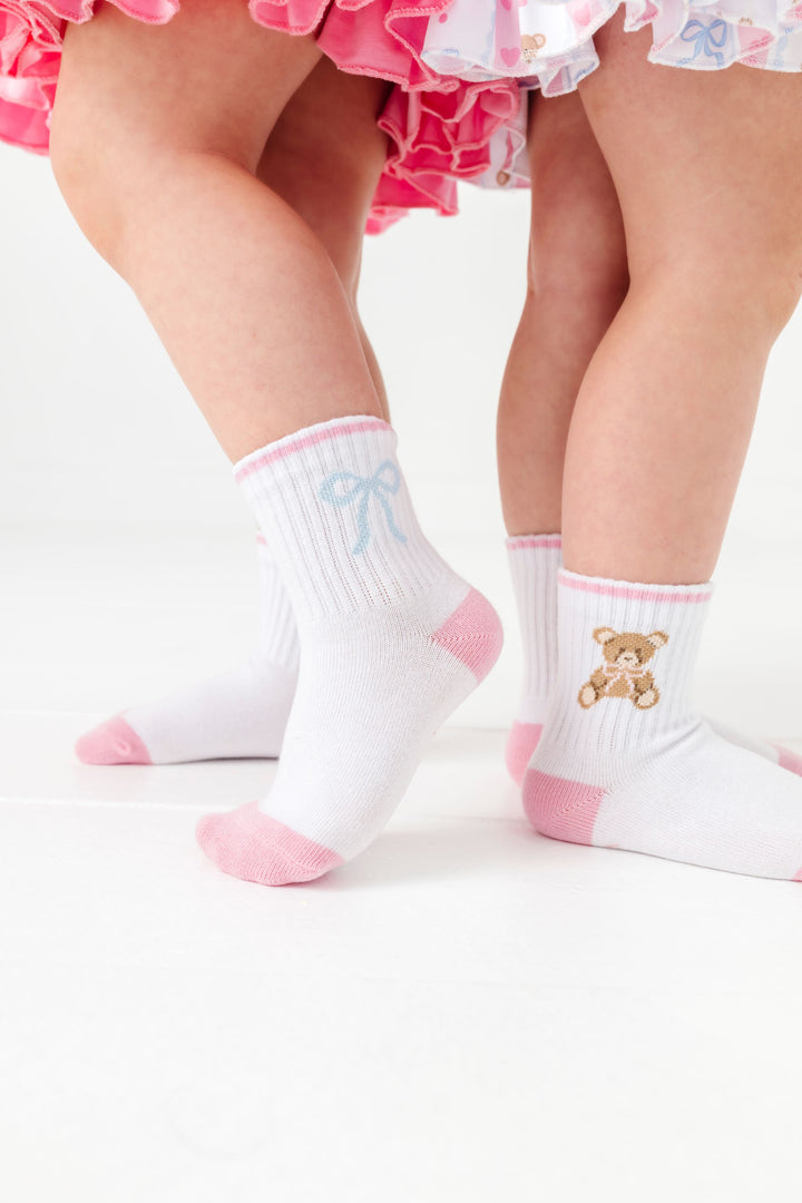 two girls in blue bow and teddy bear design socks from sock 3-pack