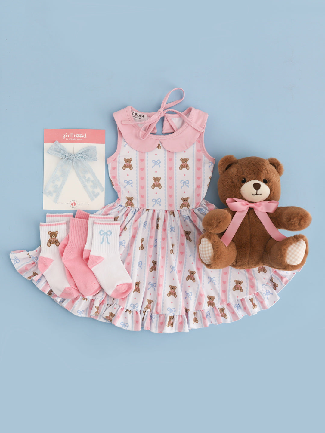 girls' vintage teddy bear print twirl dress in pink and blue on white base paired with matching crew sock 3-pack and light blue lace bow