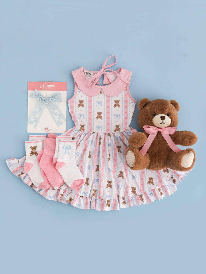 girls' vintage teddy bear print twirl dress in pink and blue on white base paired with matching crew sock 3-pack and light blue lace bow
