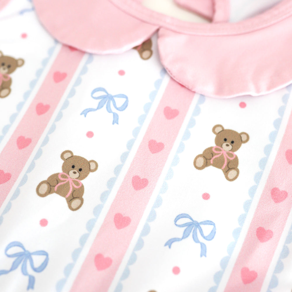 closeup of pink, white and blue vintage wallpaper inspired print twirl dress with teddy bears, bows and hearts