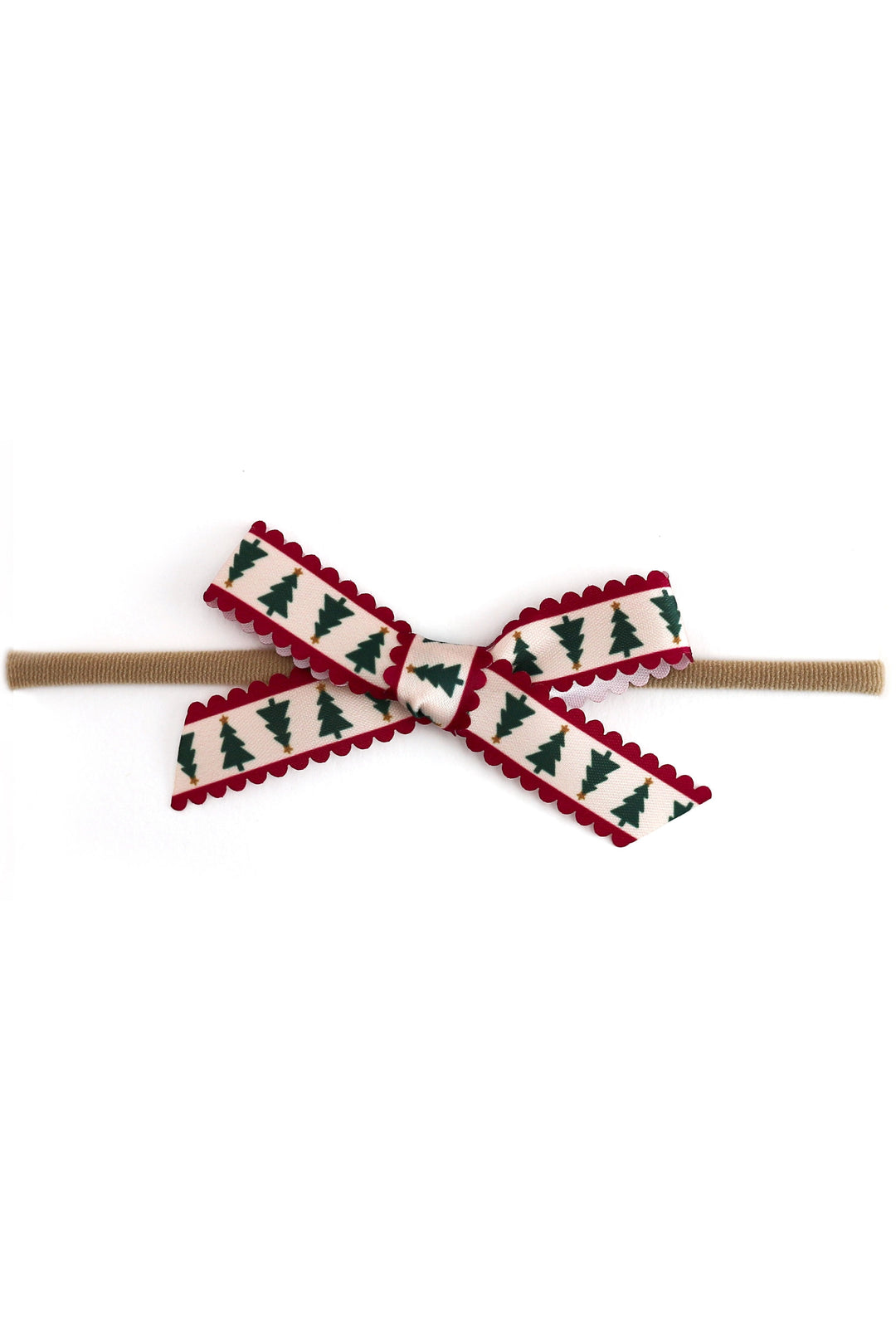scalloped ribbon baby bow with xmas tree design on nylon headband photographed on white background