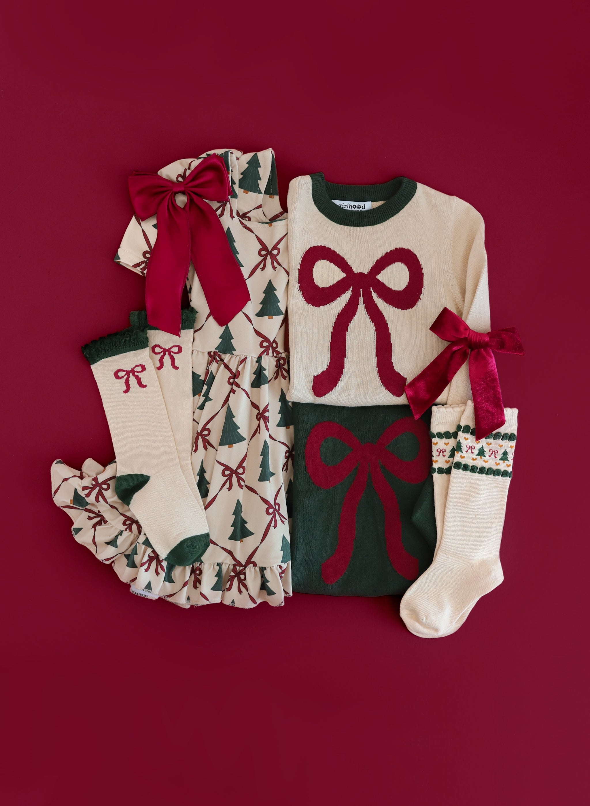 girls crimson bow themed Christmas mix and match featuring Christmas tree dress with crimson ribbon detail and matching sweaters, socks and bows
