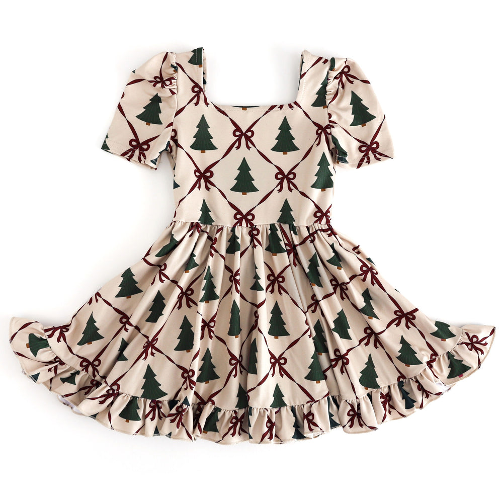 girls short sleeve cream Christmas twirl dress with crimson bow design and green pine tree print