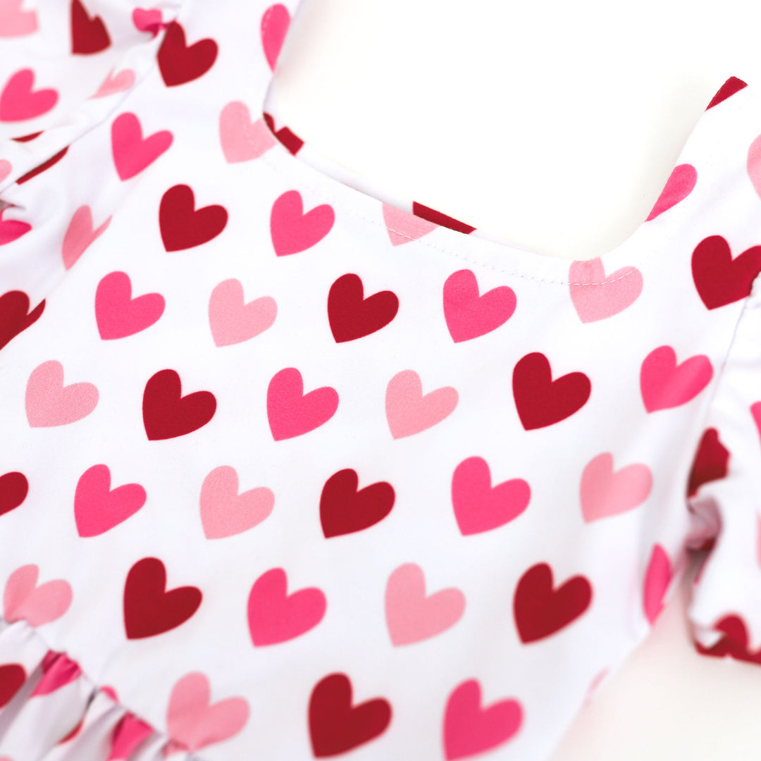 closeup of white dress with red and pink heart print