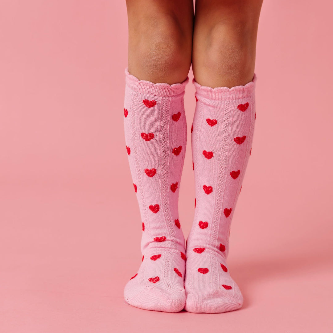 girl in light pink scallop trimmed knee high socks with red heart pattern for valentines day