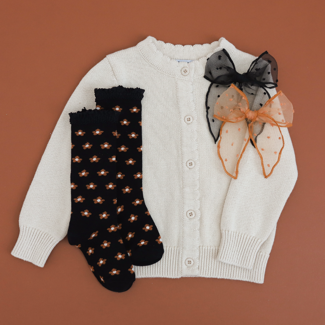 girls' cream knit cardigan paired with black fall floral knee socks and black and brown sheer hair bows 
