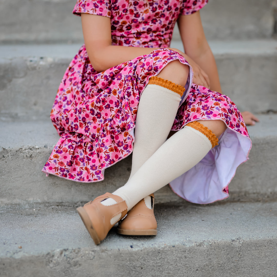 girl wearing vanilla and knee highs with mustard lace and floral dress