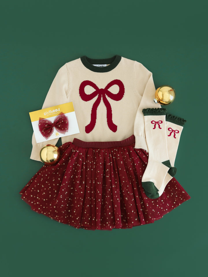 girls cream knit Christmas sweater with crimson bow design, matching knee-high socks and crimson tulle skirt and hair bow with gold sparkly dots