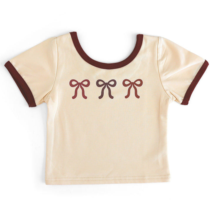 girls fitted cotton blend cream t-shirt with burgundy binding and three bows in fall colors printed on the front