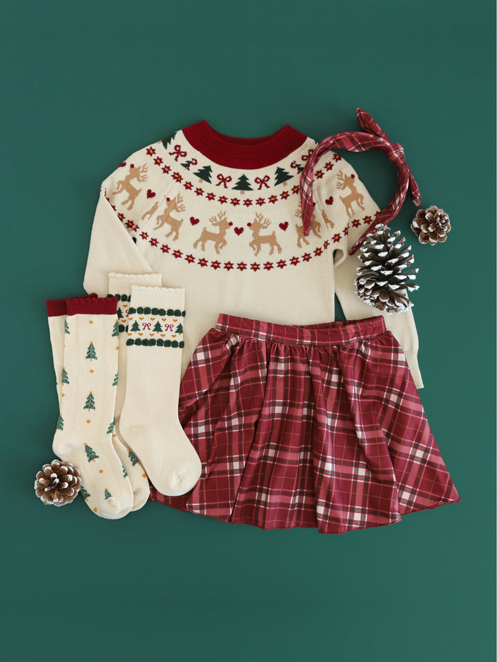 girls' Christmas outfit featuring cream fair isle reindeer print sweater and matching socks paired with crimson plaid skirt and headband