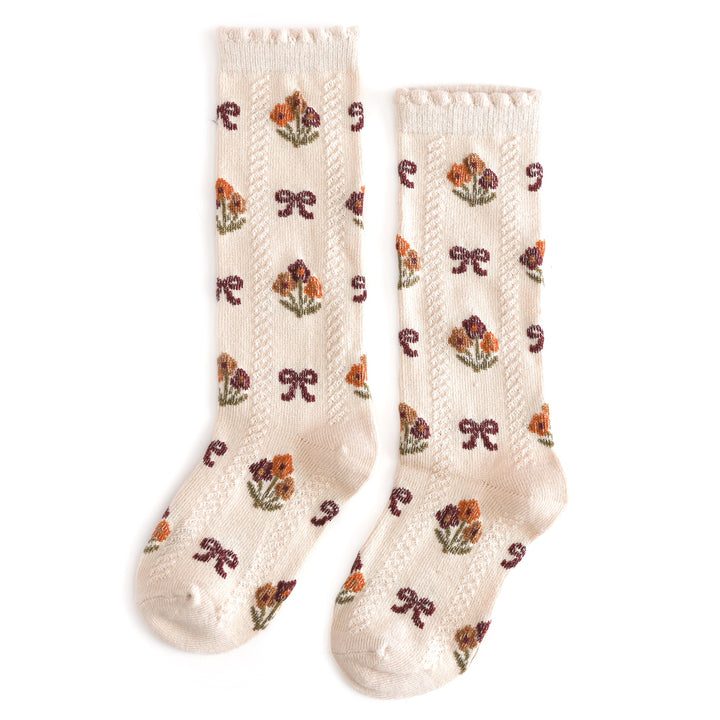 girl's scallop trimmed cream knee high socks with all over fall flower and bow pattern