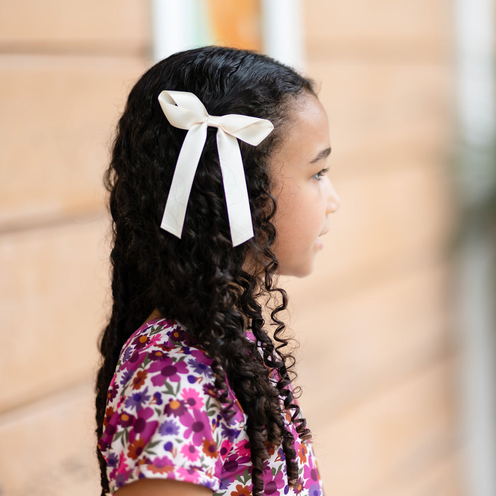 girl in autumn pink and purple floral top paired with cream satin ribbon bow on clip 