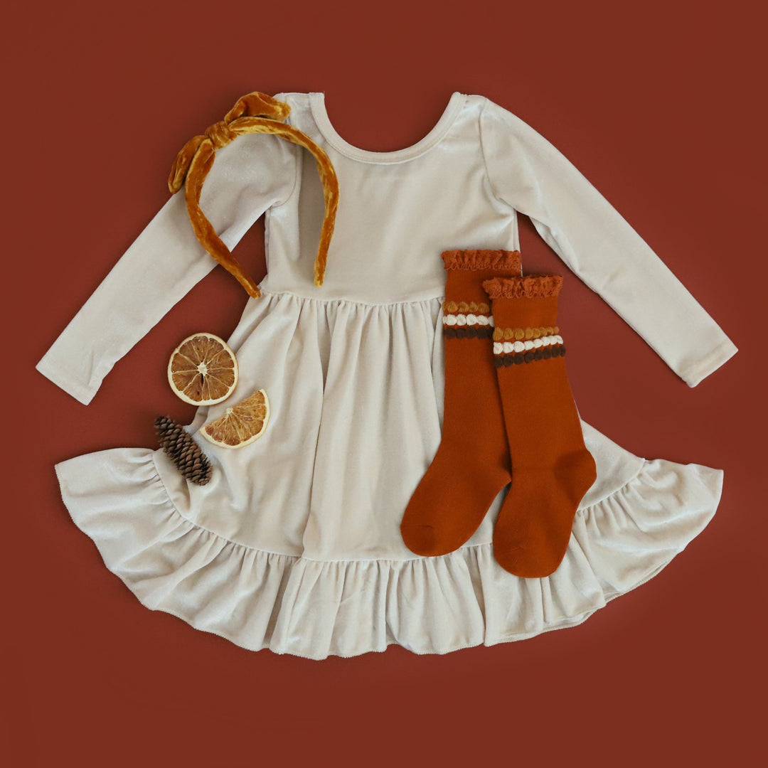 girls cream velvet twirl dress with long sleeves and coordinating mustard velvet headband and pumpkin spice embellished knee highs