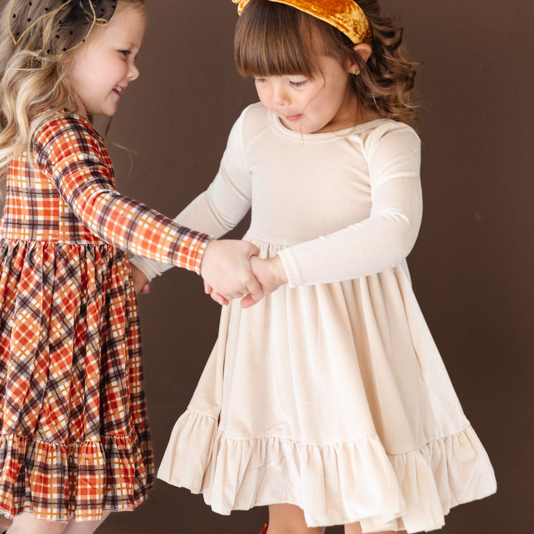 girls in fall long sleeve velvet twirl dresses with matching hair accessories