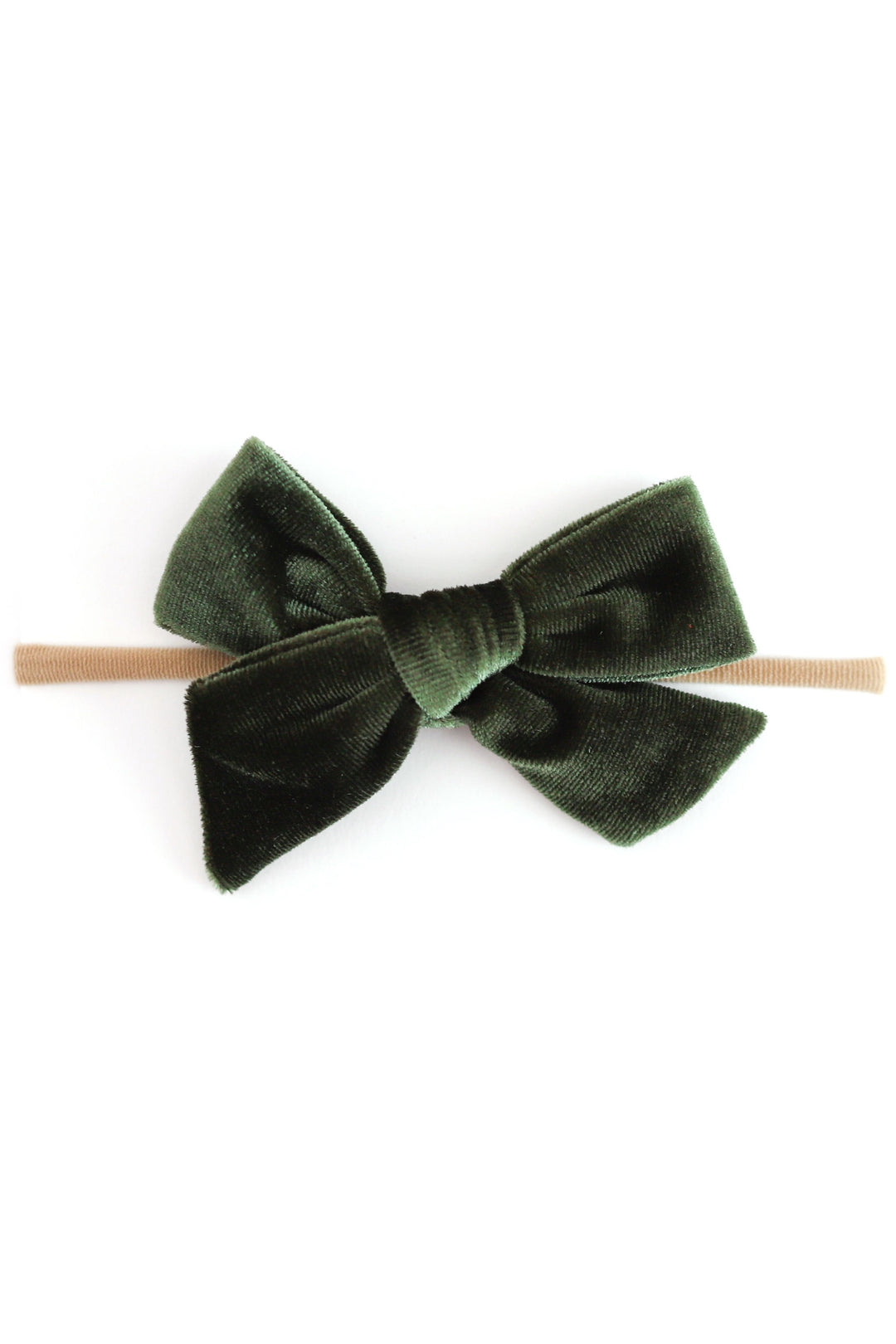 green velvet baby bow on nylon headband photographed on plain white background