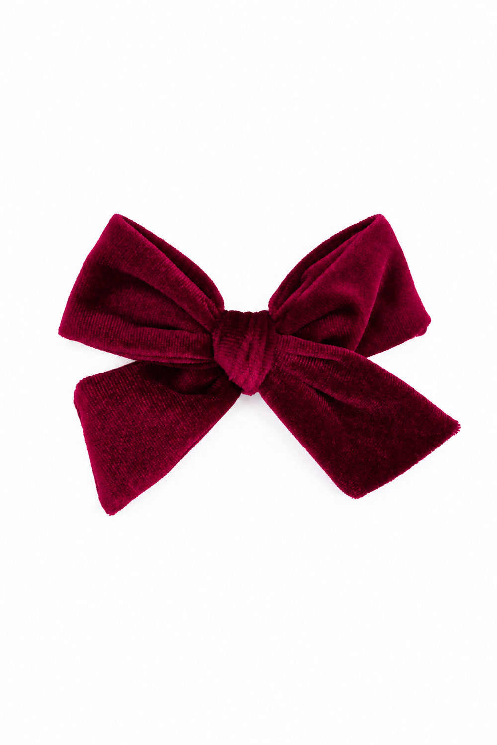 A deep burgundy velvet bow accessory, photographed against a seamless white background.