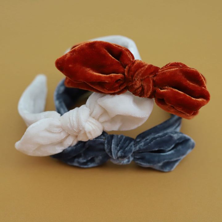 stack of three velvet headband bows in ivory, denim blue and pumpkin spice