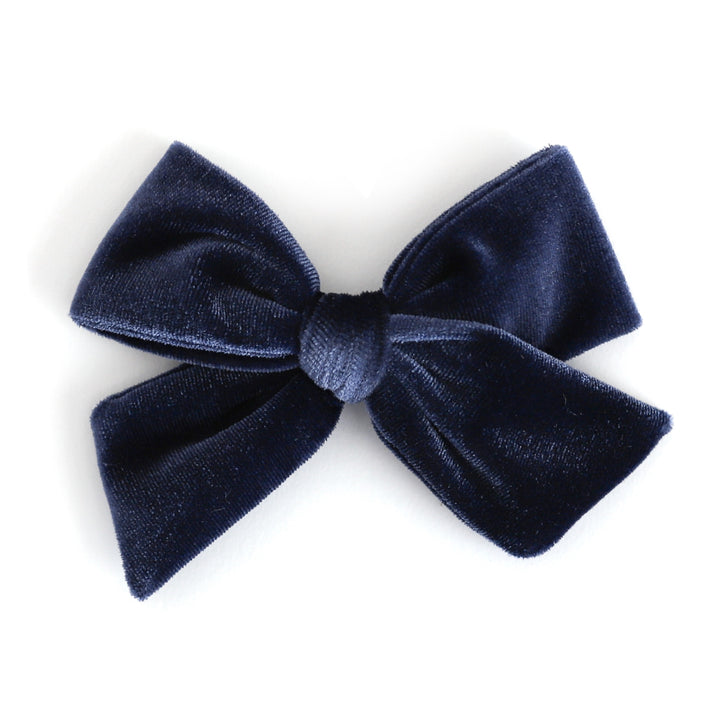 A dark navy blue velvet bow with a textured, plush fabric finish, photographed against a clean white background.