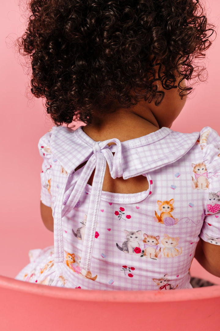 back view of tie back on collared lavender gingham twirl dress with vintage kitten print