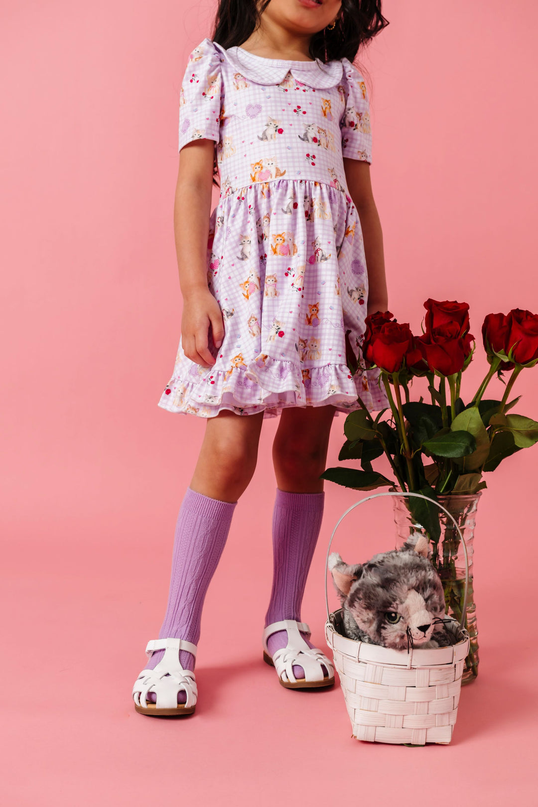 girl with red roses wearing vintage kitten print lavender twirl dress for Valentine's day paired with matching lavender cable knit knee high socks