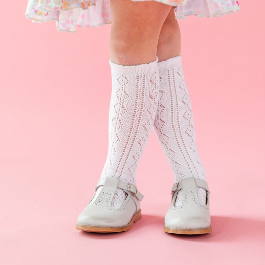 little girl white wearing open knit knee high socks with scalloped trim for spring