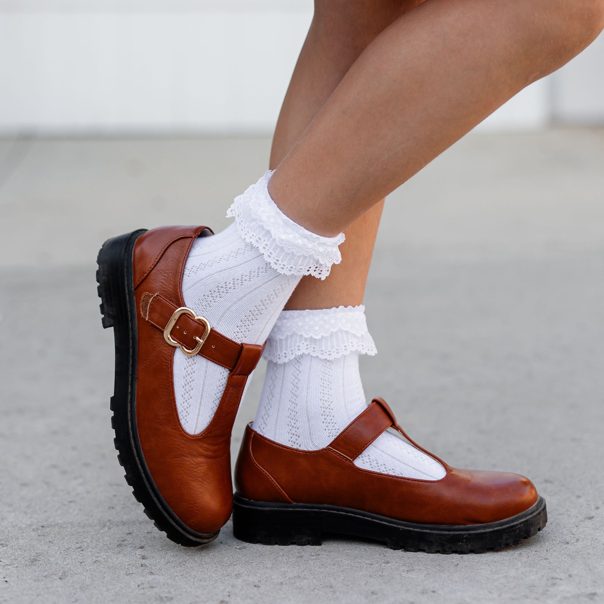 Brown shoes with white socks on a light background