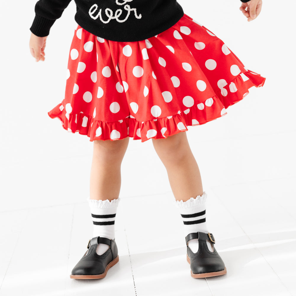little girl in minnie mouse inspired dress with white and black striped lace trimmmed midi socks