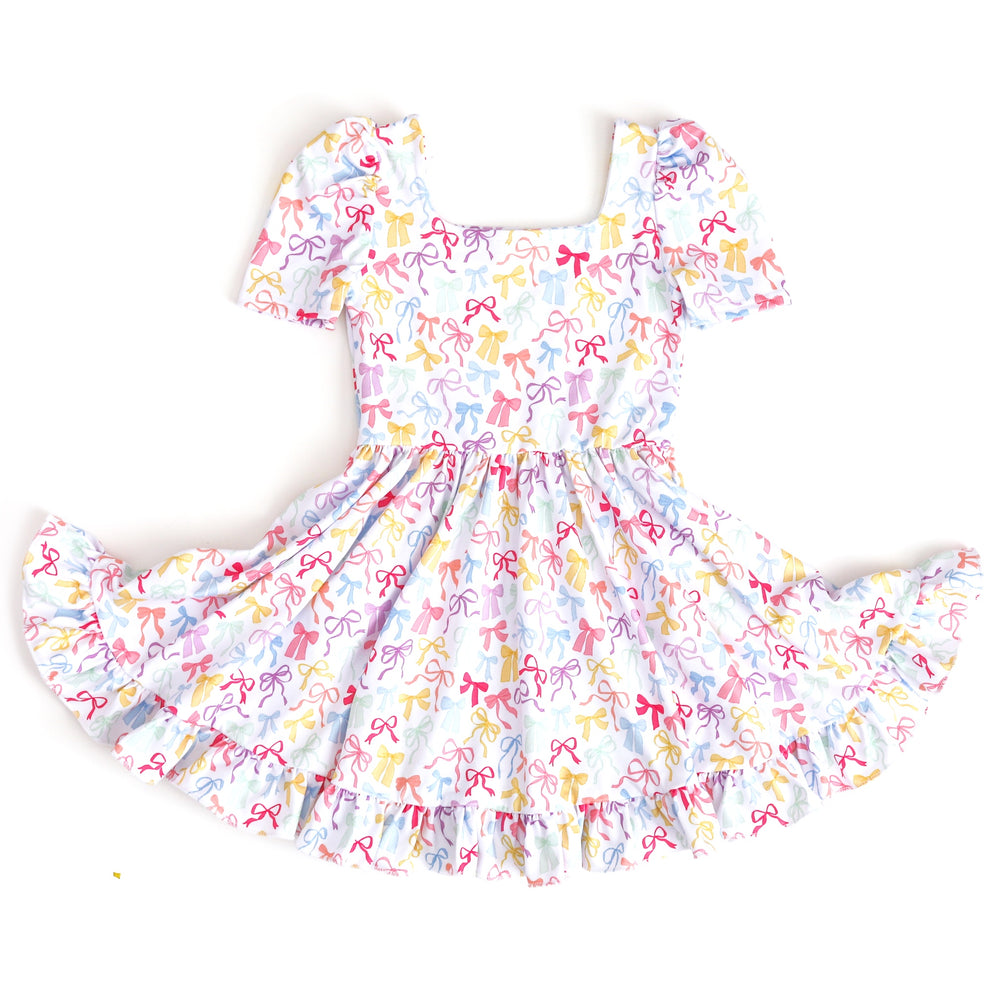 girl's square neck twirl dress in white with pastel multicolor bow print for spring