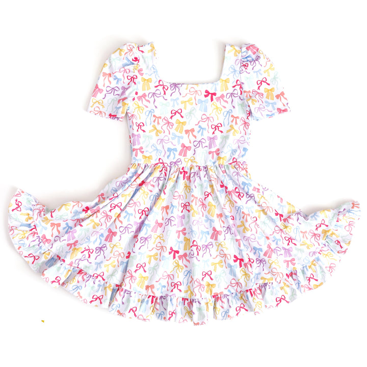 girl's square neck twirl dress in white with pastel multicolor bow print for spring