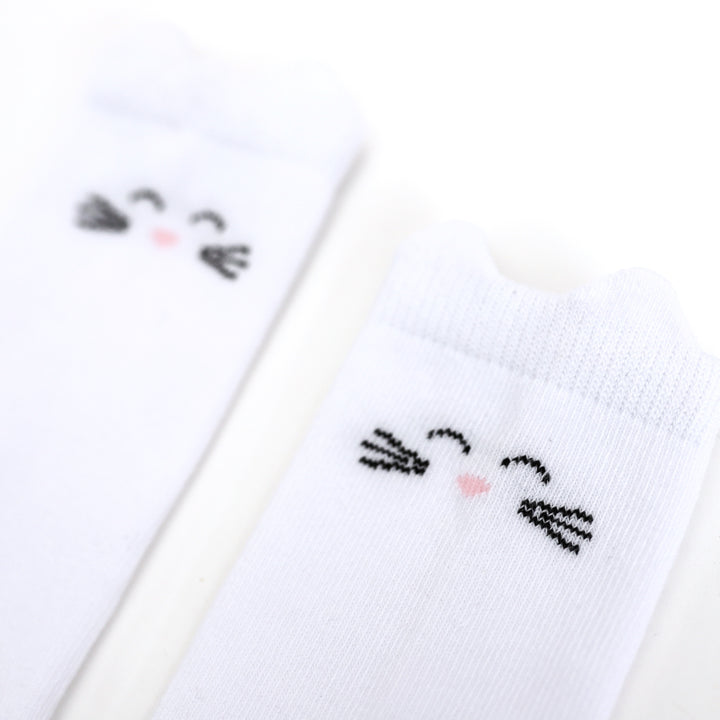 closeup of girl's white cat knee highs socks with ears