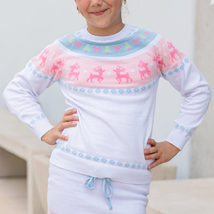 girl in white cotton knit pullover sweater with pink and blue reindeer fair isle print and matching sweater skirt
