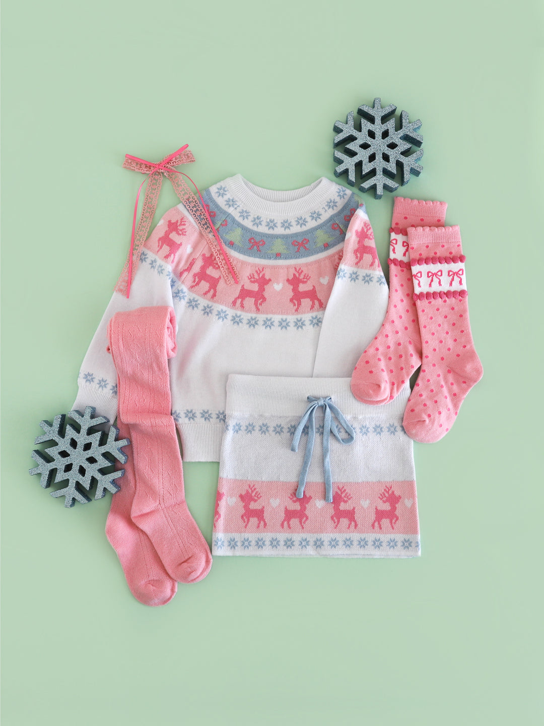 girls' white winter wonderland sweater and matching sweater skirt with pink and blue fair isle reindeer print and matching pink stockings and bow