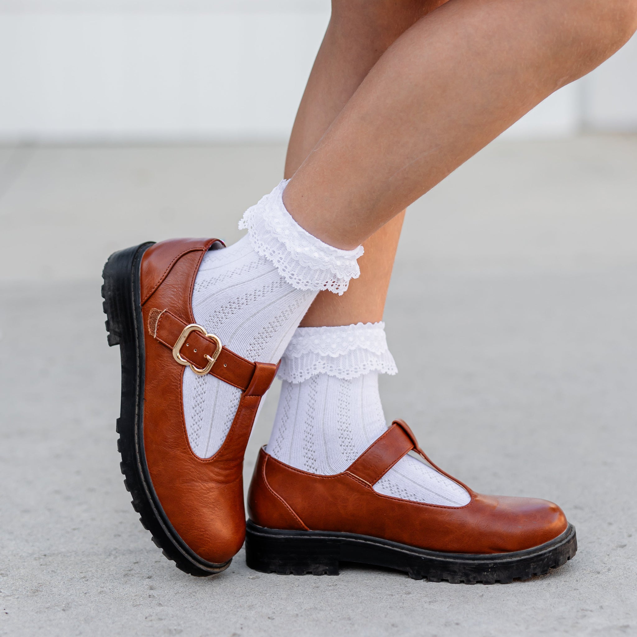 Brown shoes with white socks on a light background