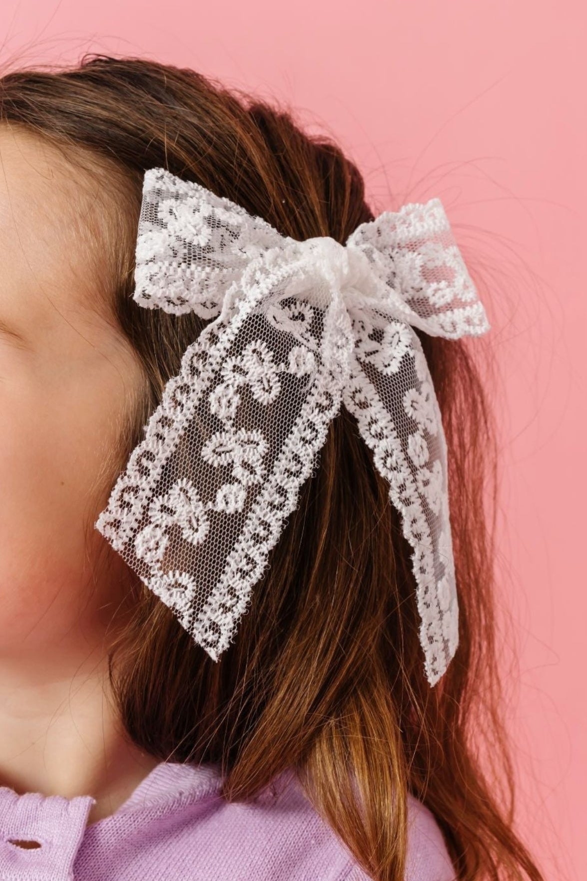 young girl in white lace hand tied hair bow on clip and lavender cardigan for spring and valentines day