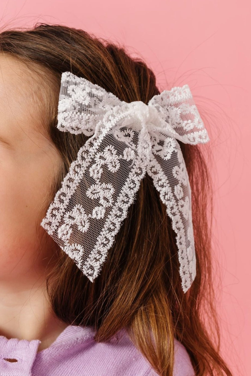 young girl in white lace hand tied hair bow on clip and lavender cardigan for spring and valentines day
