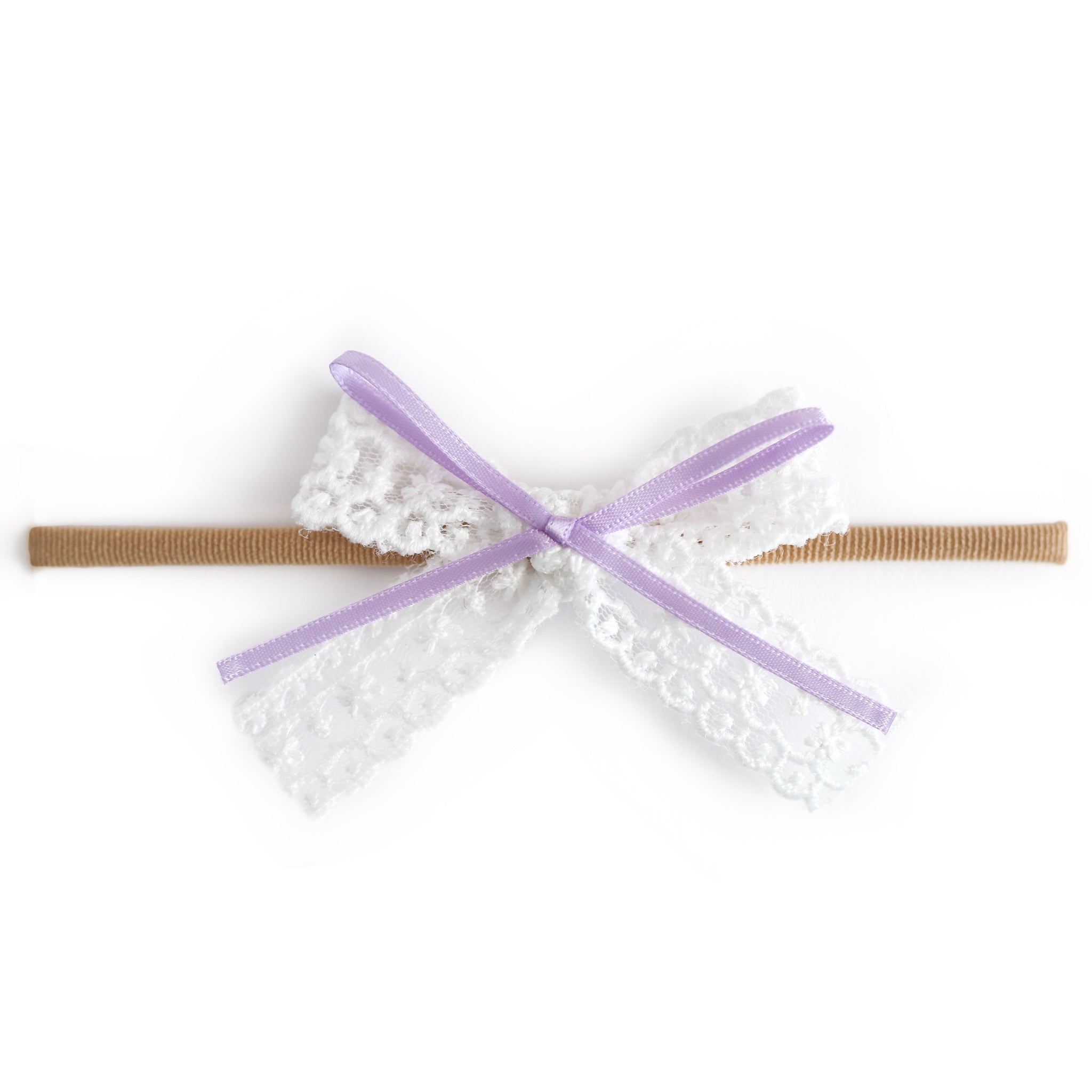 baby girl white lace hair bow with light purple ribbon detail attached to soft stretchy nude nylon headband
