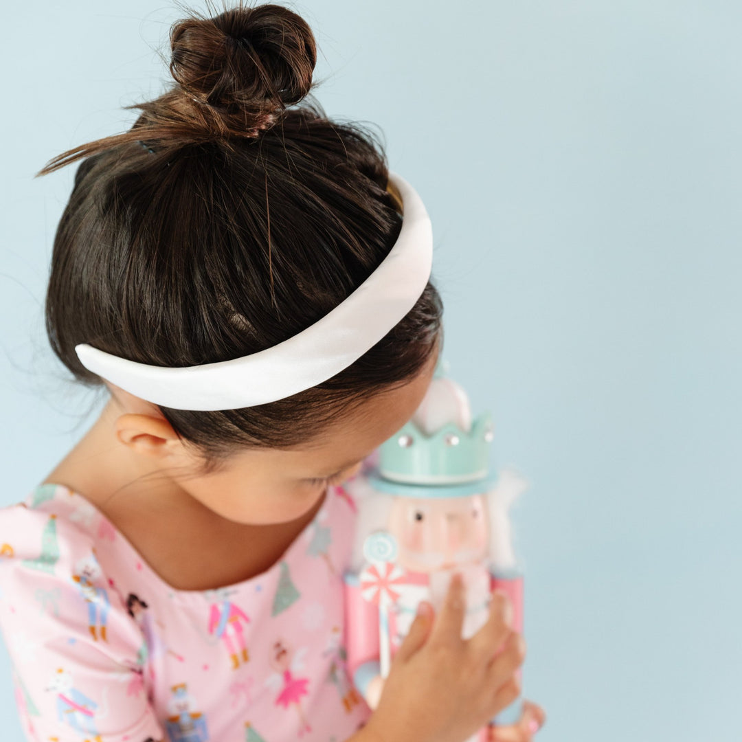 girl with nutcracker dress in white satin padded headband