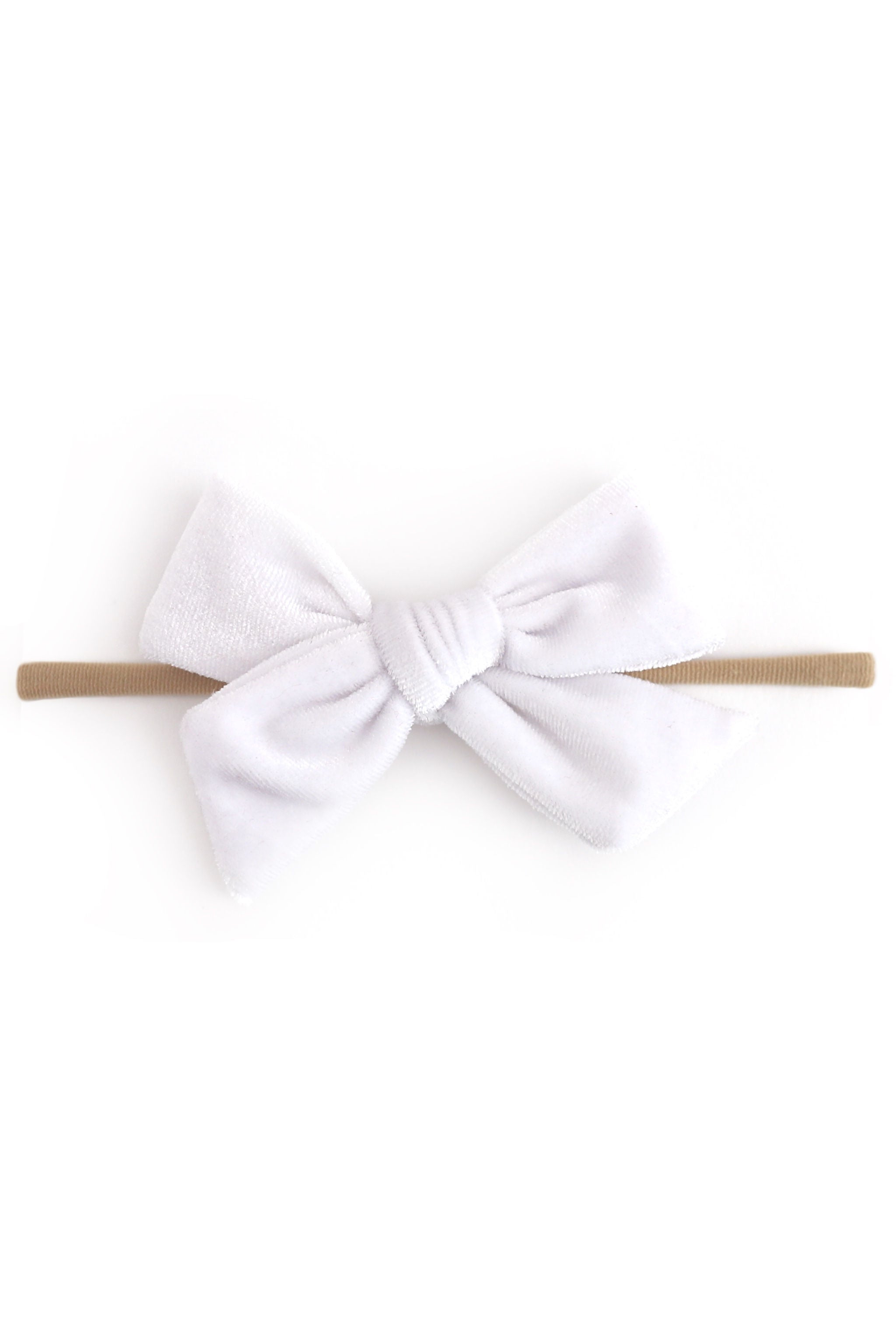 A white velvet baby bow headband on a solid white background.