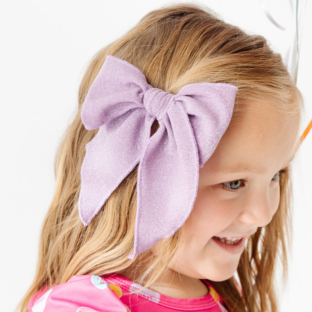 girl wearing wisteria purple sparkle party bow 