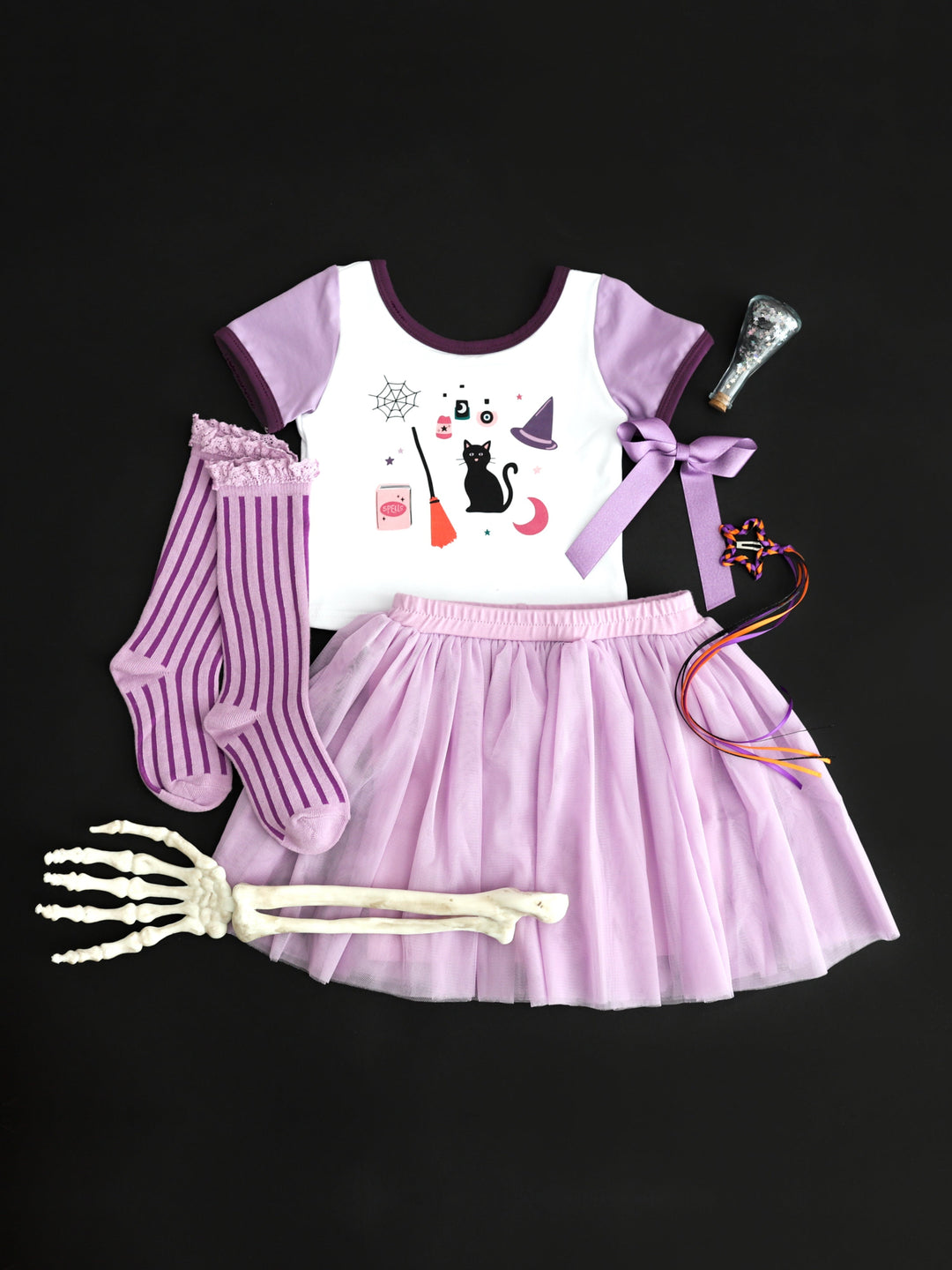 girls' witchy themed Halloween print fitted tee with two tone purple short sleeves paired with matching tutu skort, knee highs and bows in shades of purple