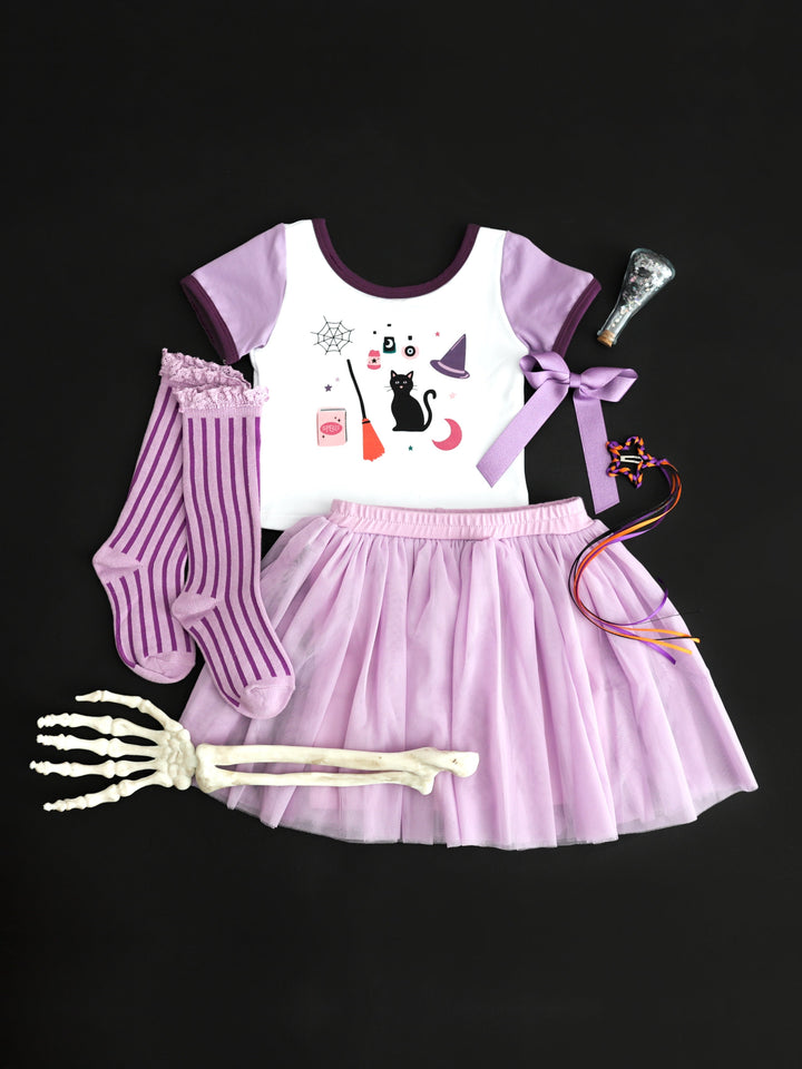 girls' witchy themed Halloween print fitted tee with two tone purple short sleeves paired with matching tutu skort, knee highs and bows in shades of purple