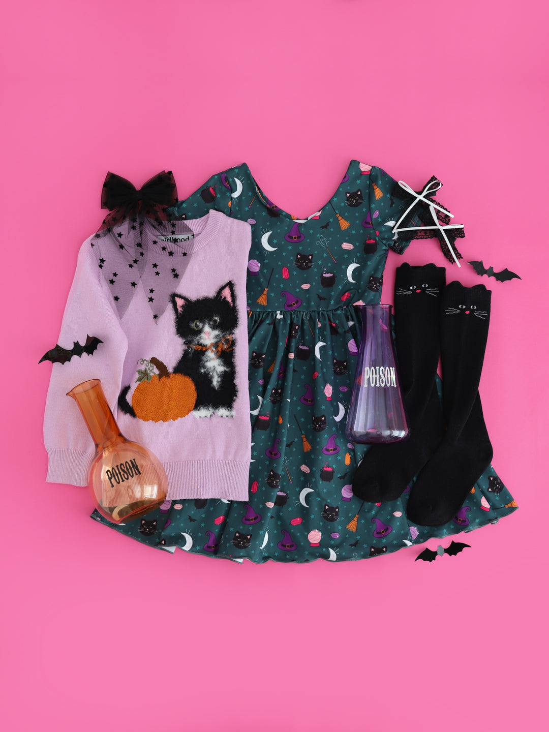 flat lay photo on bright pink featuring teal witch print twirl dress, lavender cotton knit sweater with fluffy black cat and sparkly pumpkin design, black cat knee socks and coordinating hair bows