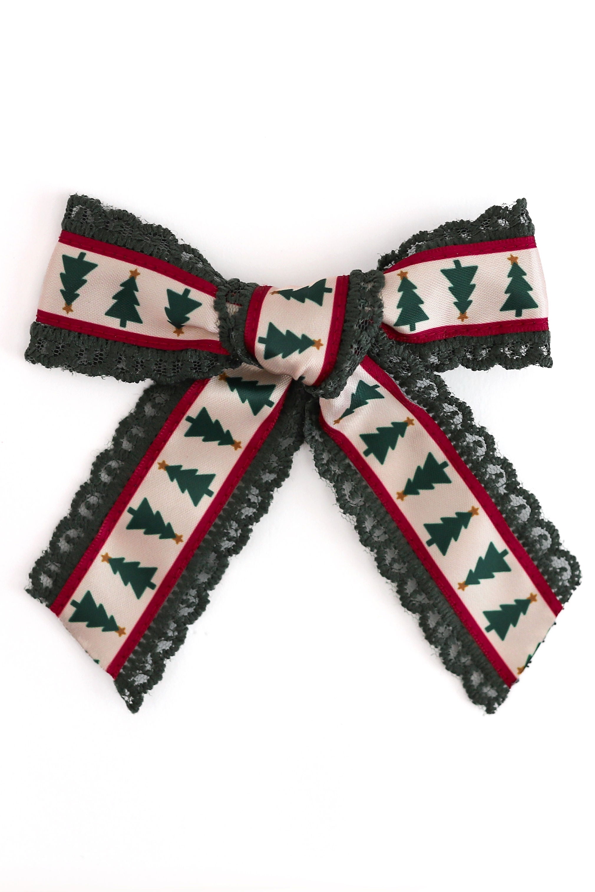 printed xmas tree ribbon hair bow sewn on dark green lace shown on white background