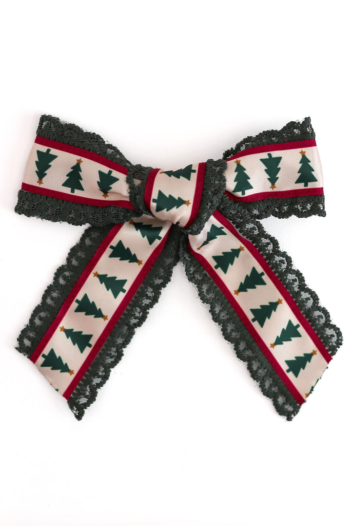 printed xmas tree ribbon hair bow sewn on dark green lace shown on white background