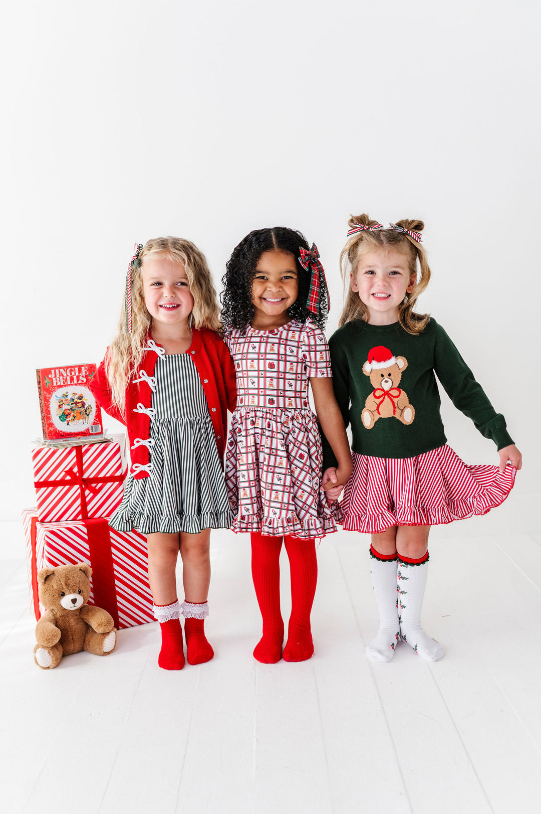3 girls wearing teddy bear christmas themed outfits