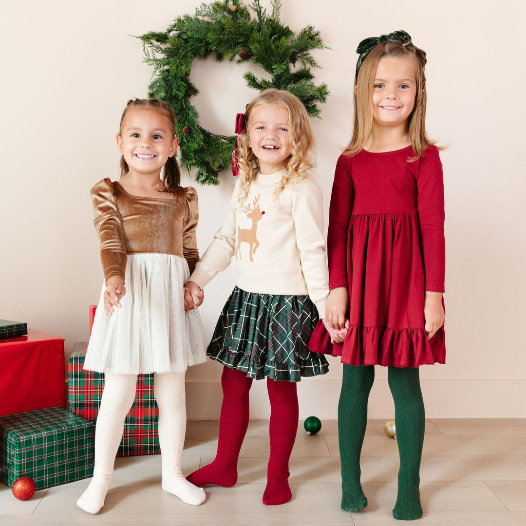 girls wearing christmas party dresses with matching tights