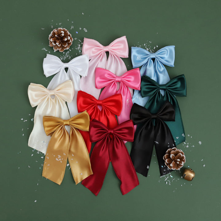 big satin hair bows in a variety of colors including red, pink, gold, white, forest green, cream